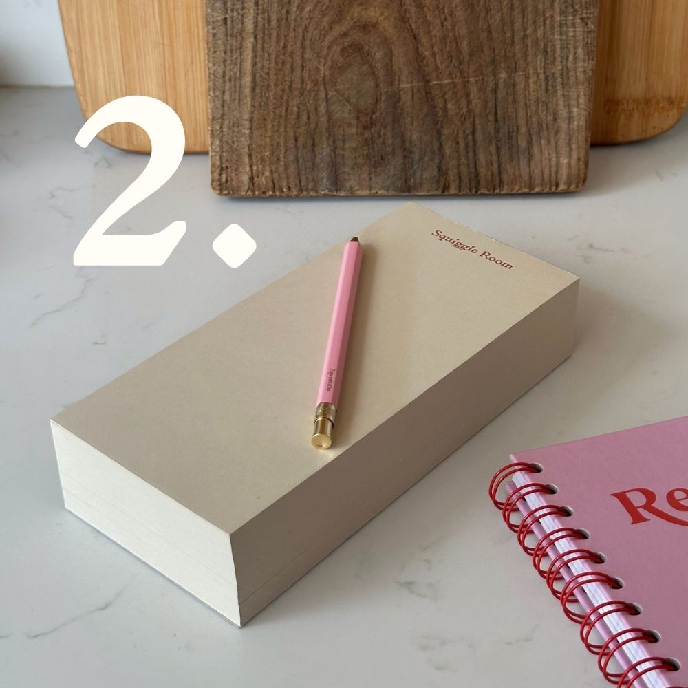 Pink pen on a creative block pad