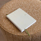 Small notebook on a textured brown surface