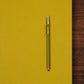 Green pencil on a yellow background