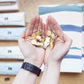 Gold Rama Eye Clips in hands