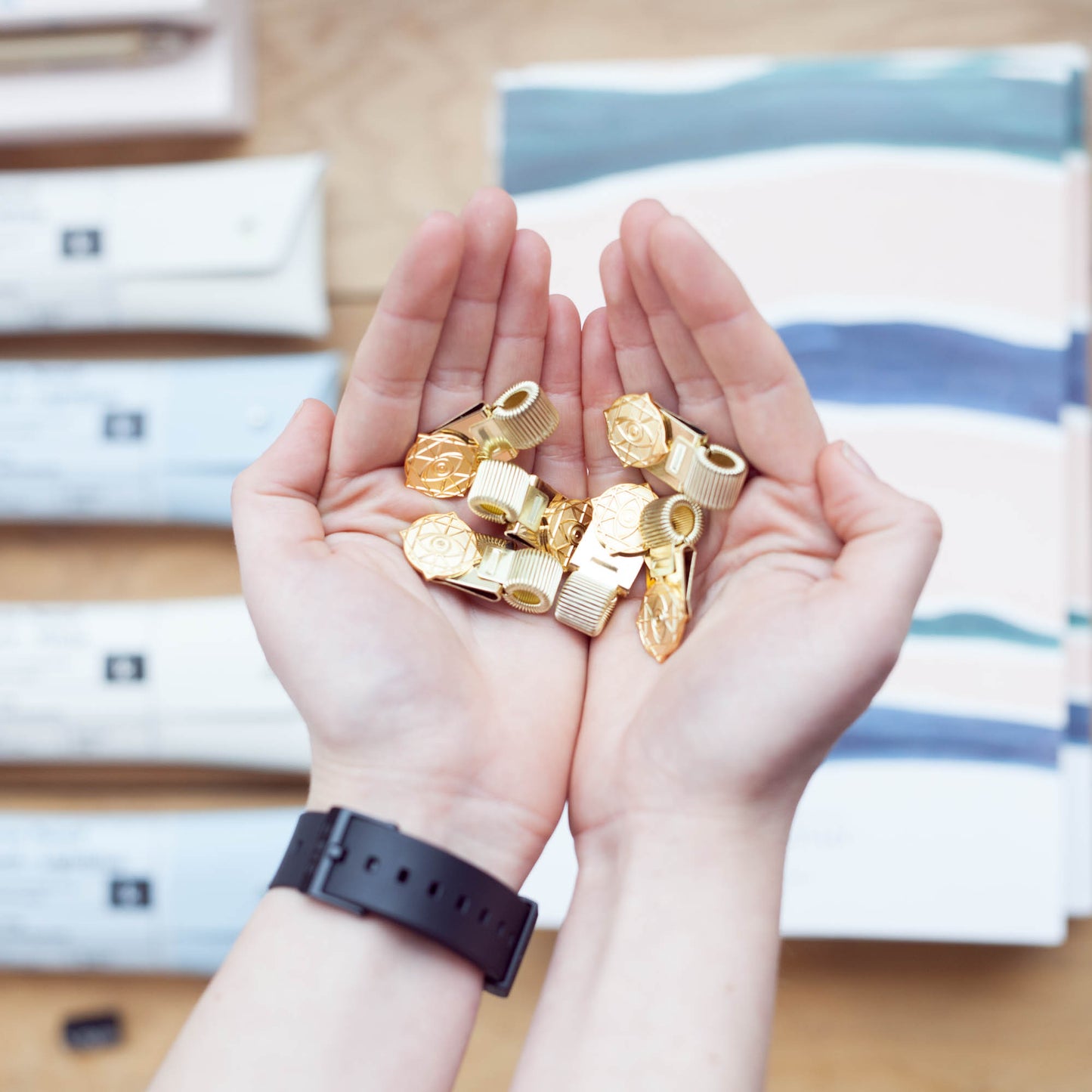 Gold Rama Eye Clips in hands