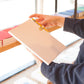 Gold Pen Clip attached to Notebook